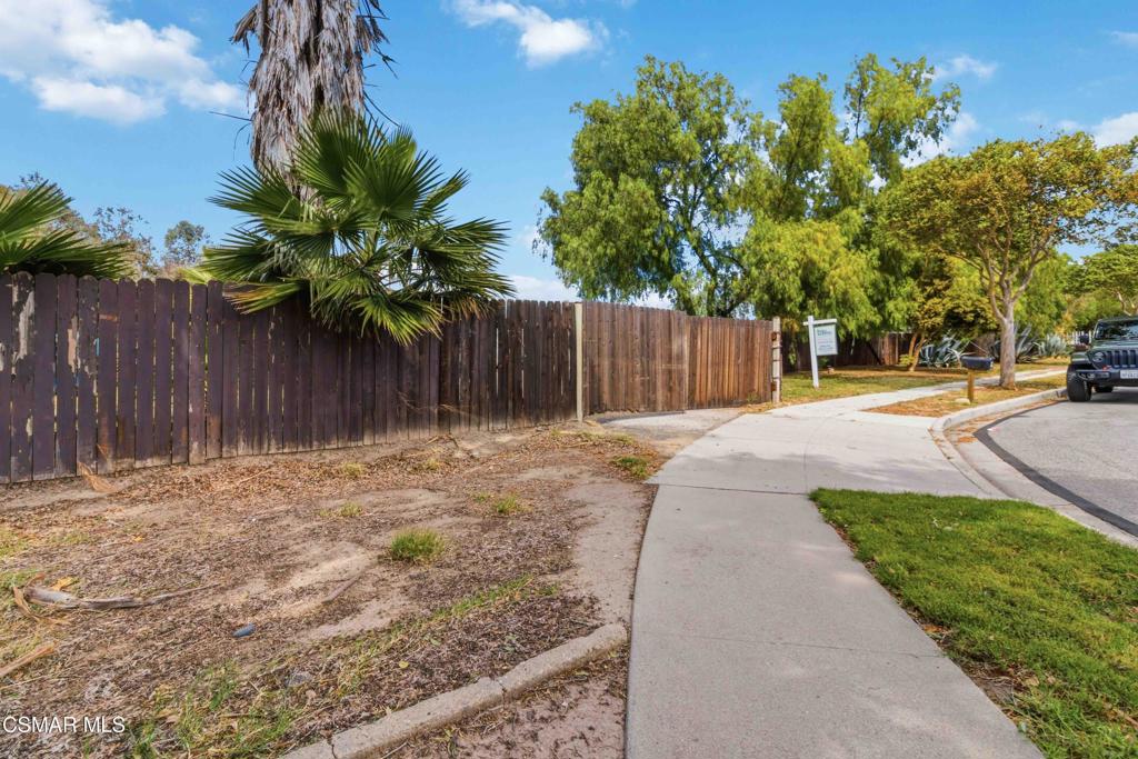 2874 School Street Simi Valley, CA 93065 - Photo 22 of 48 a backyard of a house with table and chairs plants and large tree