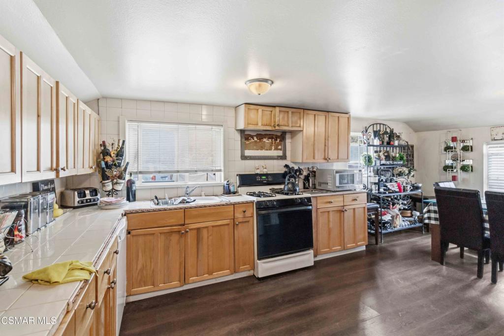 2874 School Street Simi Valley, CA 93065 - Photo 10 of 48 a kitchen with stainless steel appliances granite countertop a sink stove and wooden cabinets