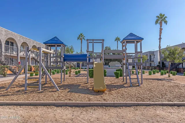 a front view of a house with garden and trees