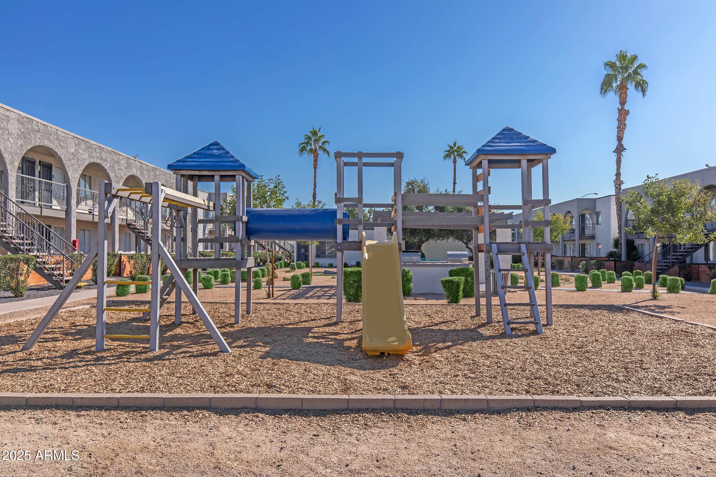 10860 North 85th Avenue, Unit 2 Peoria, AZ 85345 - Photo 15 of 16 a front view of a house with a yard