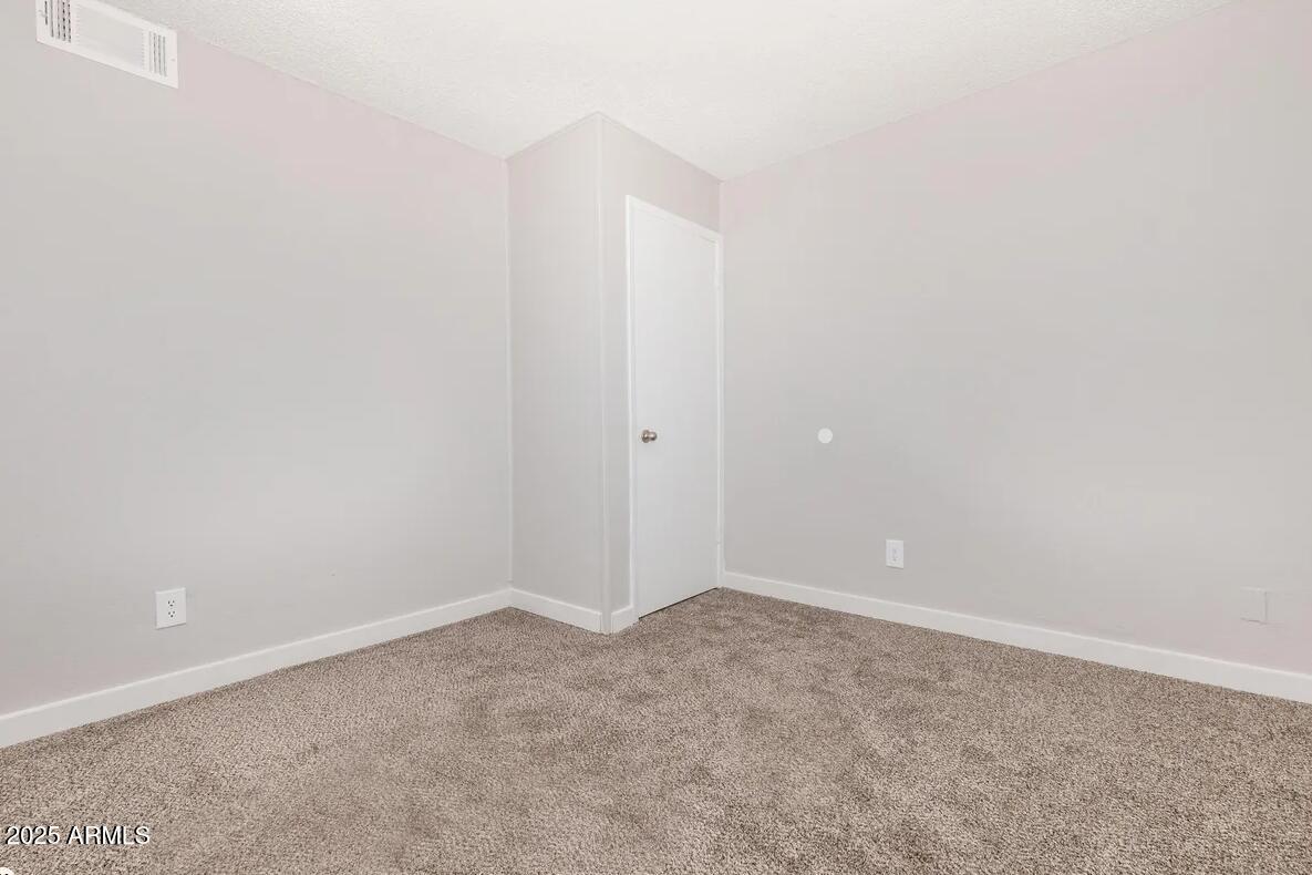 10860 North 85th Avenue, Unit 2 Peoria, AZ 85345 - Photo 6 of 16 a view of an empty room