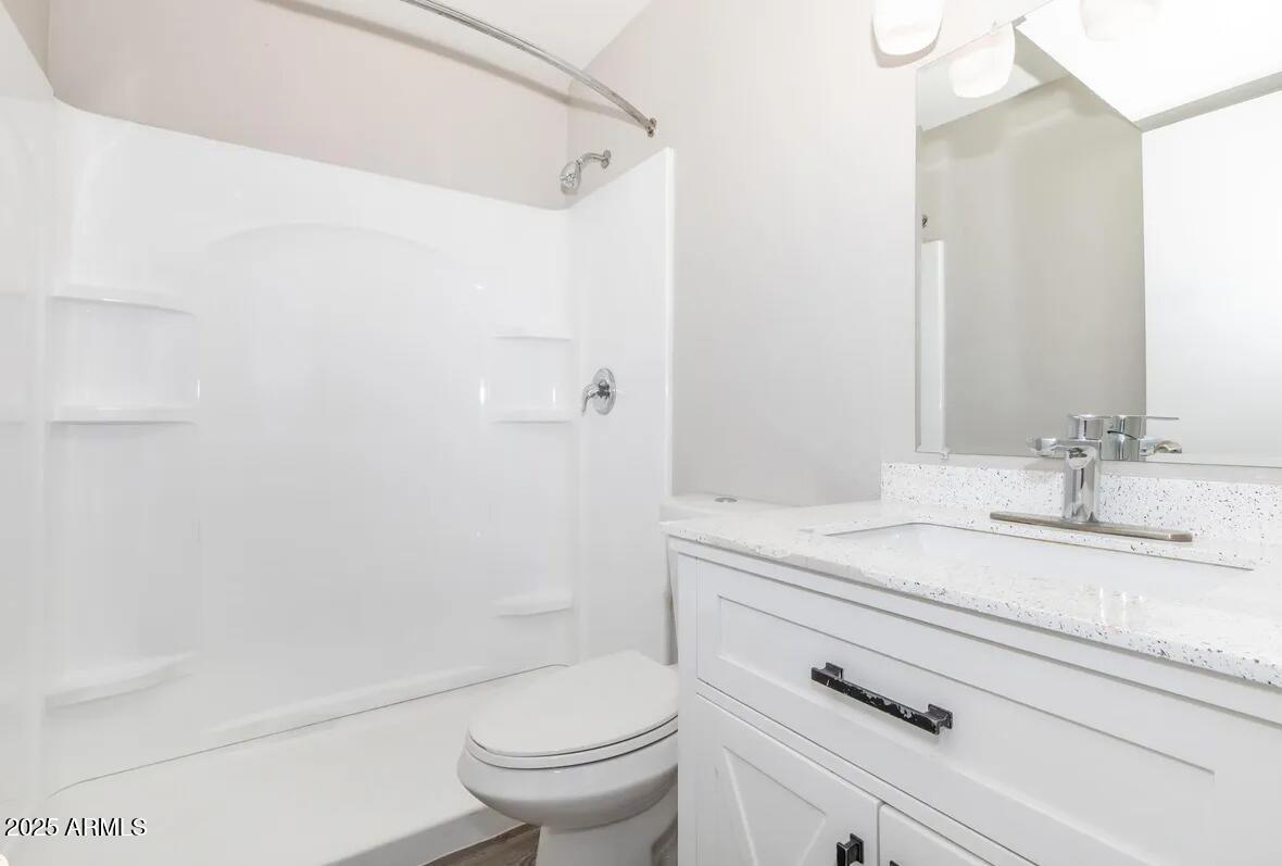10860 North 85th Avenue, Unit 2 Peoria, AZ 85345 - Photo 8 of 16 a bathroom with a sink a toilet and shower
