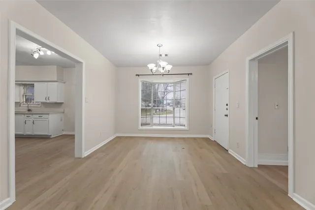 a view of kitchen with furniture electronic appliances and window
