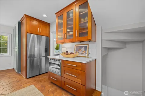 a kitchen with a refrigerator and cabinets