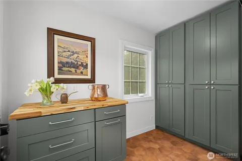 a bathroom with a granite countertop sink a vanity and a window