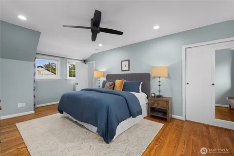 a spacious bedroom with a bed and a ceiling fan