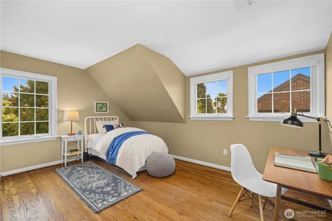 a bedroom with a bed a table and chair
