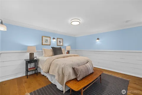 a bed room with a bed and a chair