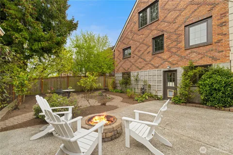 a view of a patio with table and chairs with wooden fence and plants