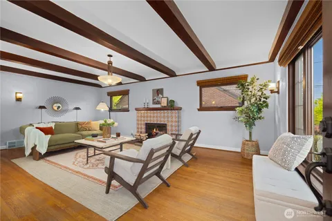 a living room with furniture and a potted plant