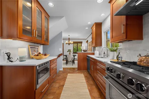 a kitchen with stainless steel appliances granite countertop a stove and a sink