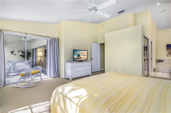 a bedroom with a bed and a mirror