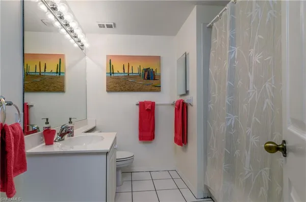 a bathroom with a sink vanity and mirror