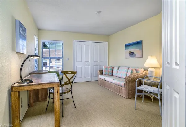 a living room with furniture a rug and a window