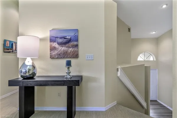 a view of a room with furniture and wooden floor