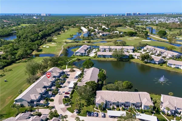 an aerial view of lake residential house with outdoor space and swimming pool