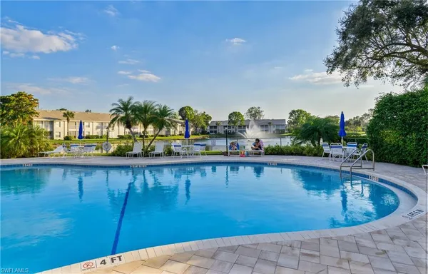a view of swimming pool with outdoor seating and plants