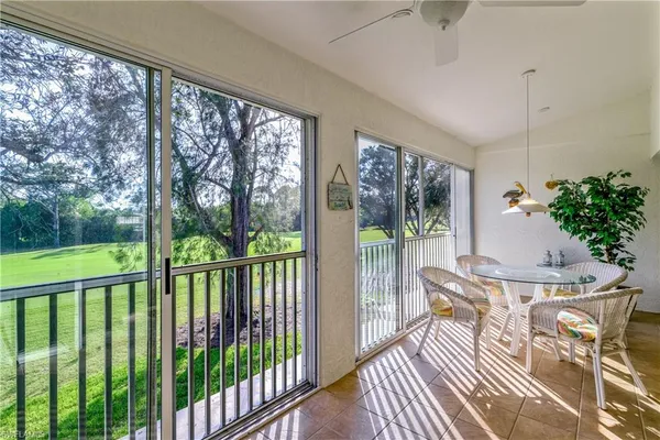a view of a porch with furniture and garden