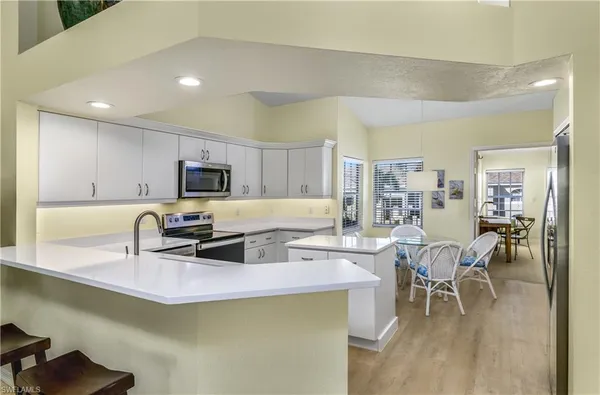 a kitchen with a sink cabinets and wooden floor