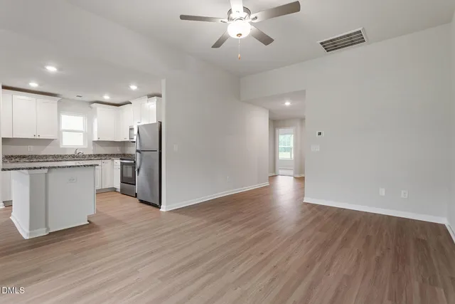 a view of kitchen with granite countertop cabinets and wooden floor
