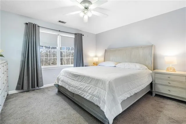 a bed sitting in a bedroom next to a window