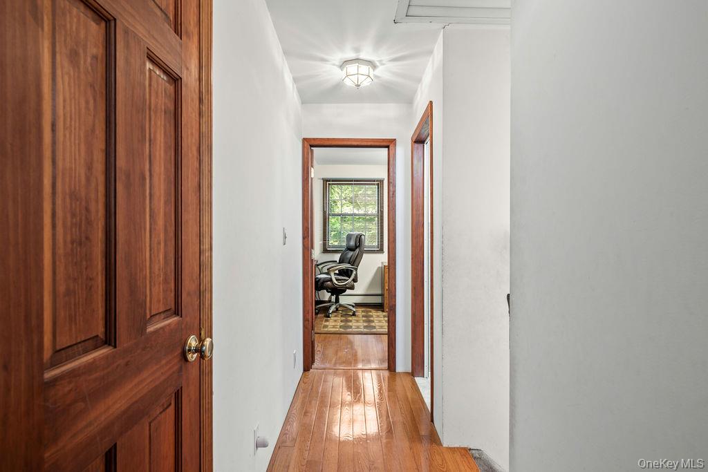 289 Seven Springs Mountain Road Monroe, NY 10950 - Photo 11 of 25 a view of a hallway with wooden floor and a dining room