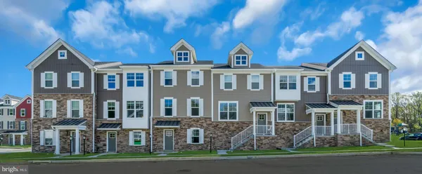 a front view of a residential apartment building with a yard