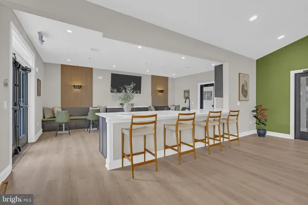 a living room with lots of furniture and a wooden floor