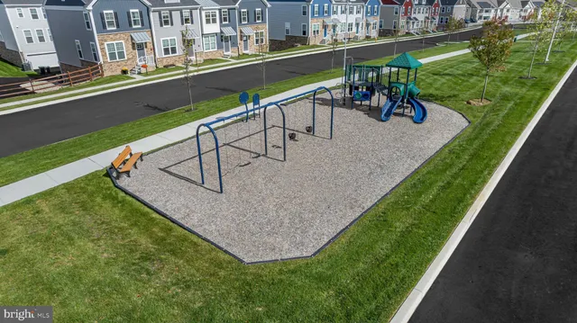a view of a house with a small yard and fence