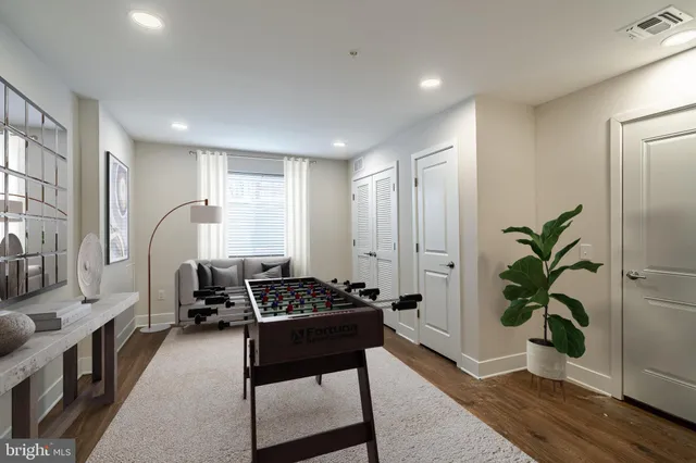 a hallway with furniture and a potted plant