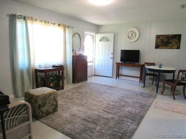 a large bedroom with a bed and a flat screen tv