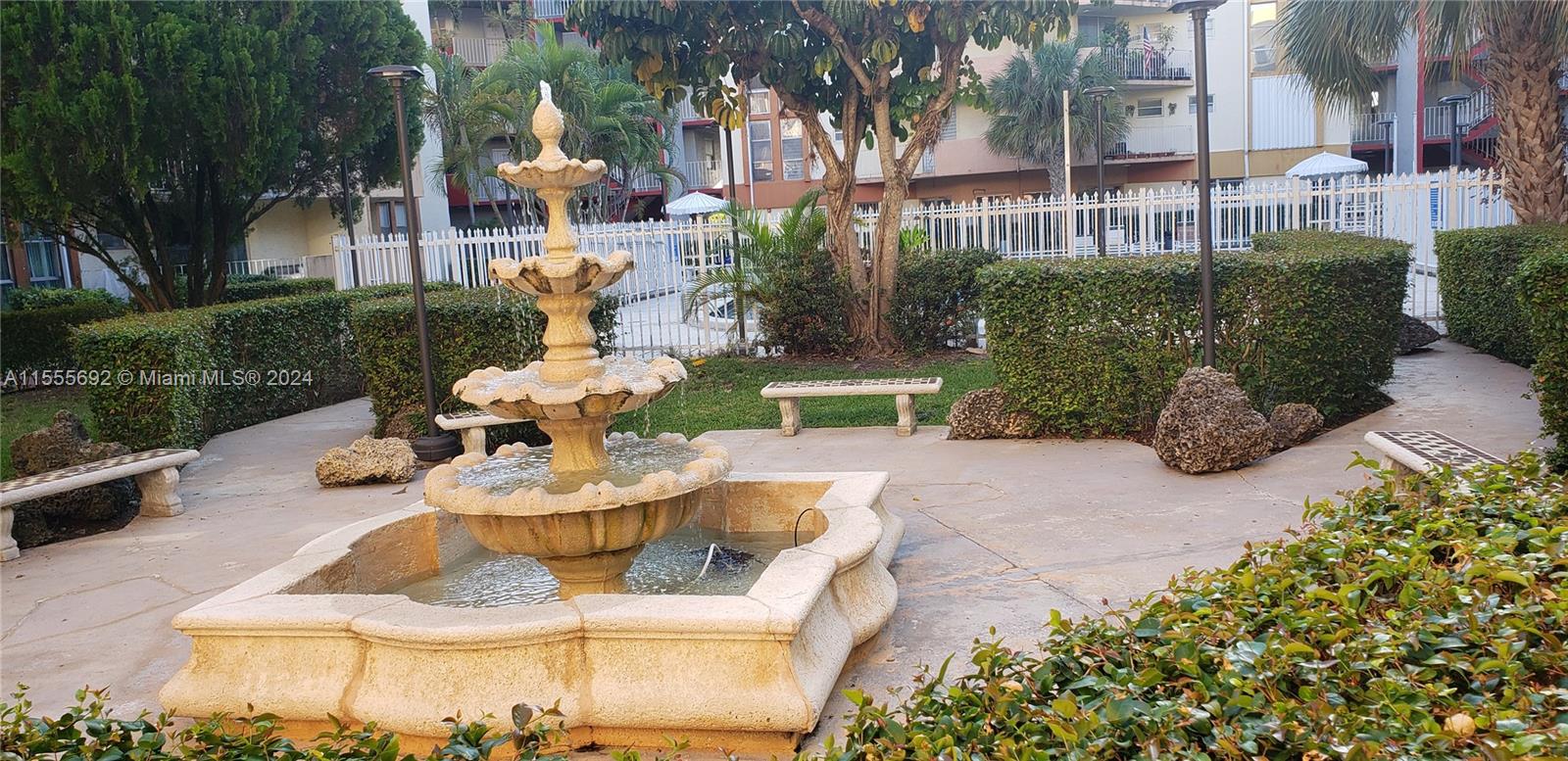 a view of a patio with couches and table and chairs and potted plants