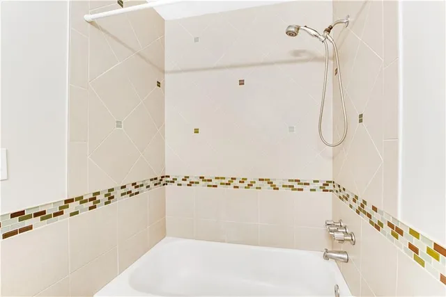 a bathroom with a shower and a shower