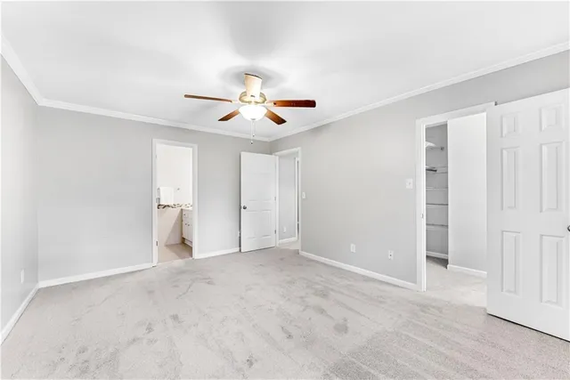a view of an empty room with a ceiling fan