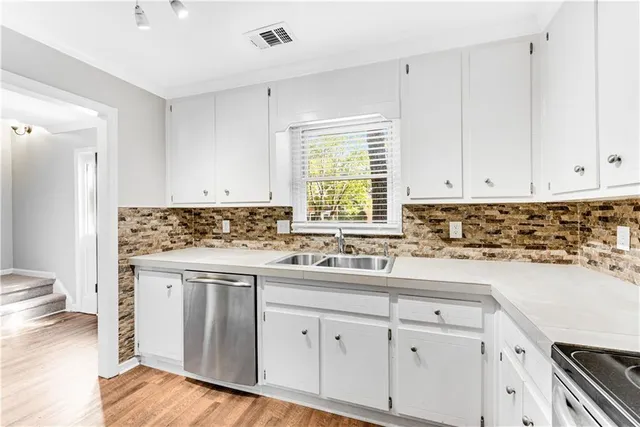 a kitchen with a sink cabinets and window