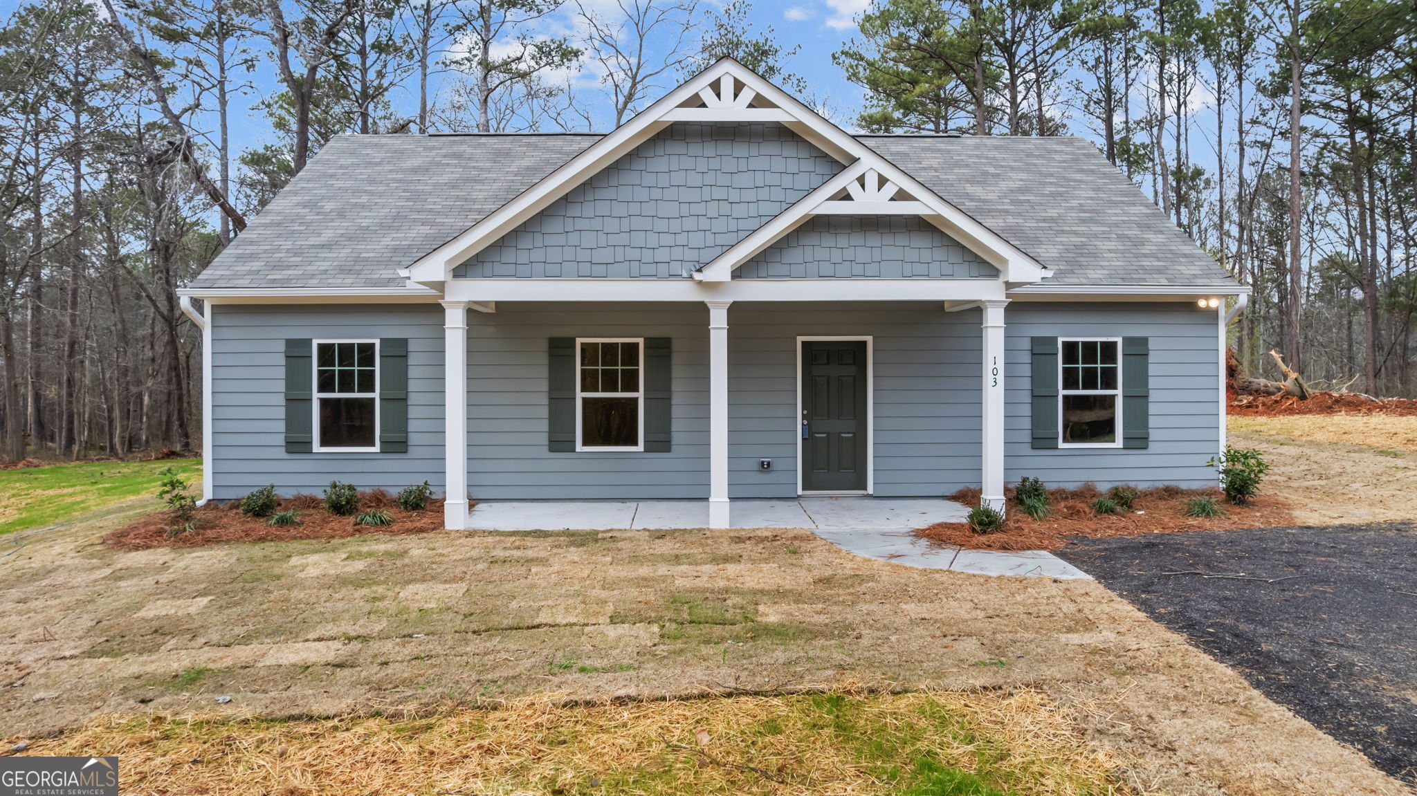 a front view of a house with a garden