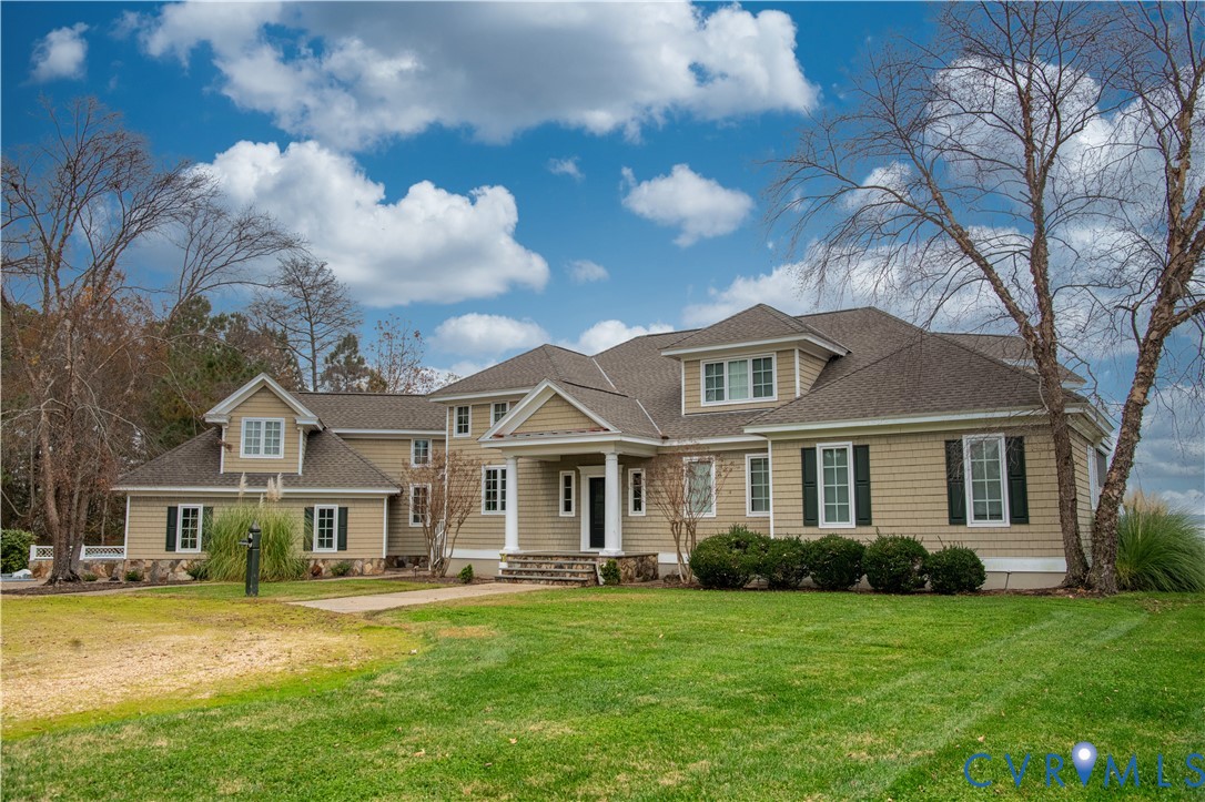463 Rockingham Road Dunnsville, VA 22454 - Photo 1 of 47 a front view of a house with a garden