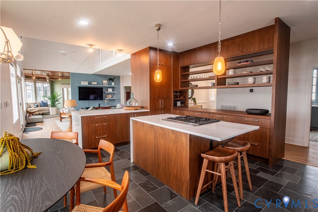 463 Rockingham Road Dunnsville, VA 22454 - Photo 18 of 47 a kitchen with stainless steel appliances kitchen island granite countertop a stove a sink dishwasher and a microwave with wooden floor