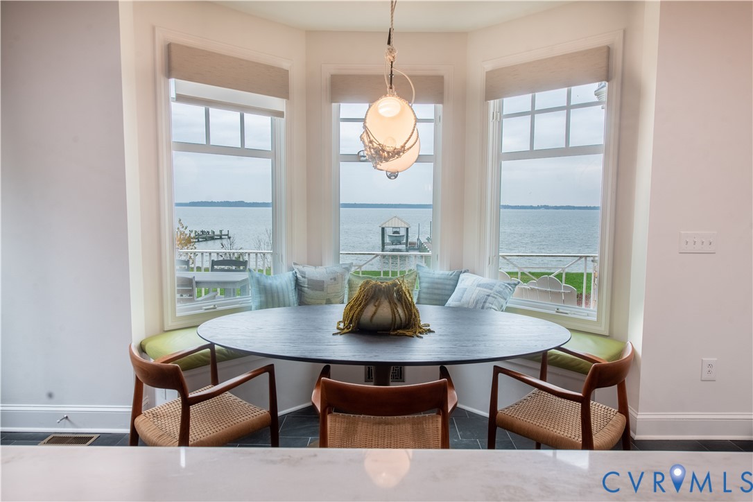 463 Rockingham Road Dunnsville, VA 22454 - Photo 20 of 47 a view of a dining room with furniture window and wooden floor