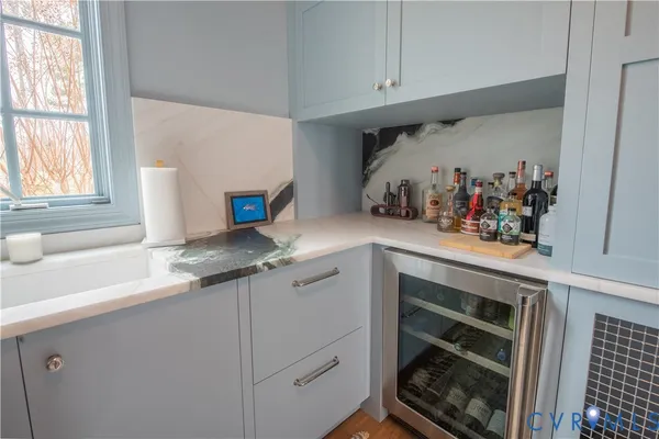 a living room with furniture a rug and a window