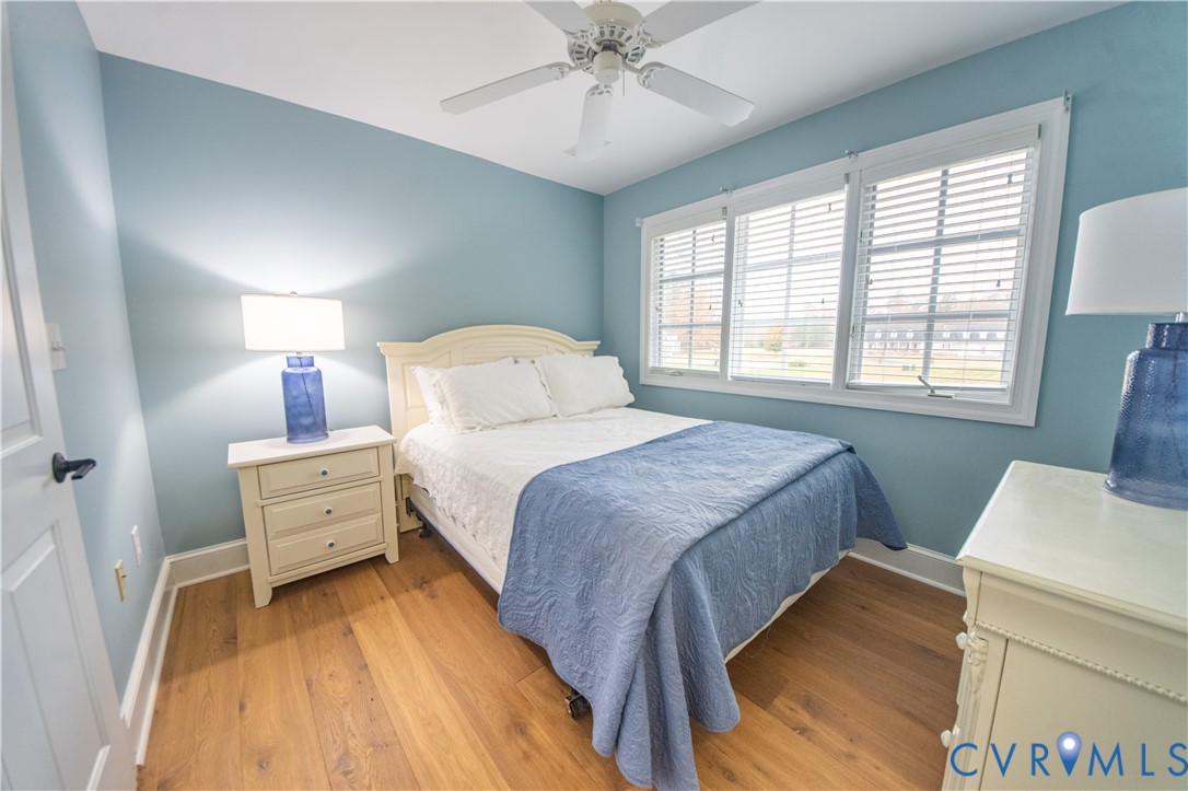 463 Rockingham Road Dunnsville, VA 22454 - Photo 28 of 47 a bedroom with a bed and a chandelier