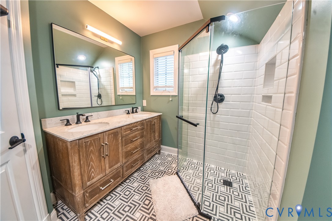 463 Rockingham Road Dunnsville, VA 22454 - Photo 29 of 47 a bathroom with a double vanity sink mirror and shower