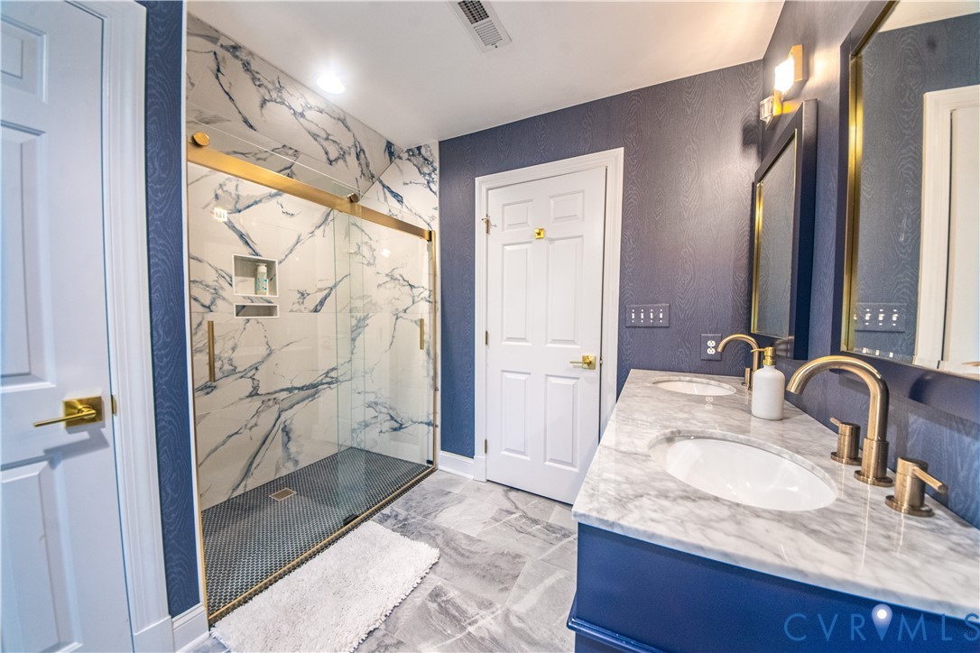 463 Rockingham Road Dunnsville, VA 22454 - Photo 33 of 47 a bathroom with a granite countertop sink and a mirror