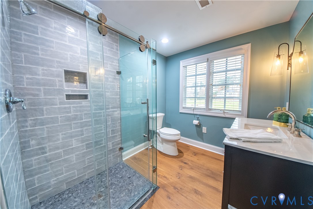 463 Rockingham Road Dunnsville, VA 22454 - Photo 35 of 47 a spacious bathroom with a granite countertop sink a toilet and shower