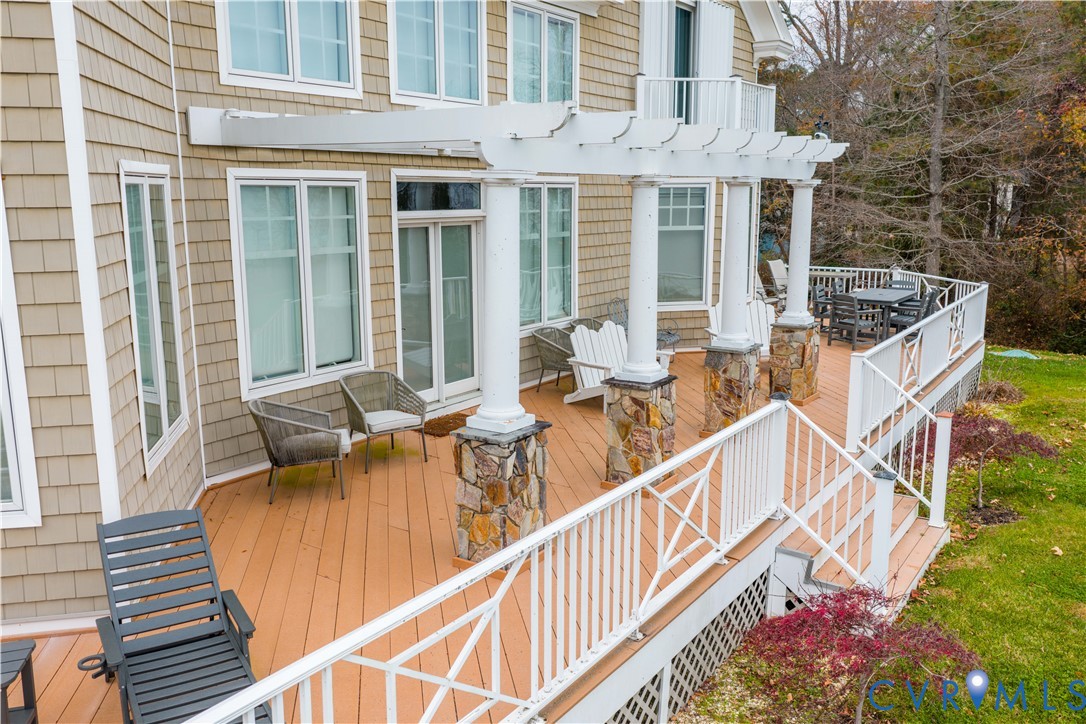 463 Rockingham Road Dunnsville, VA 22454 - Photo 38 of 47 a view of a patio with couches table and chairs and wooden floor