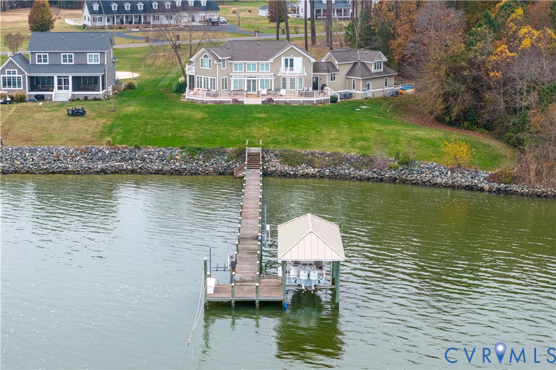 463 Rockingham Road Dunnsville, VA 22454 - Photo 4 of 47 a view of a lake with a house and a yard
