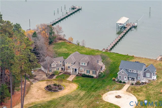 an aerial view of residential houses with outdoor space and parking