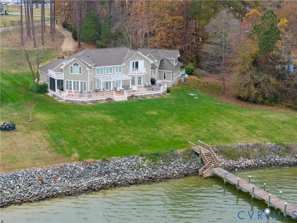 a view of a house with a big yard and large trees