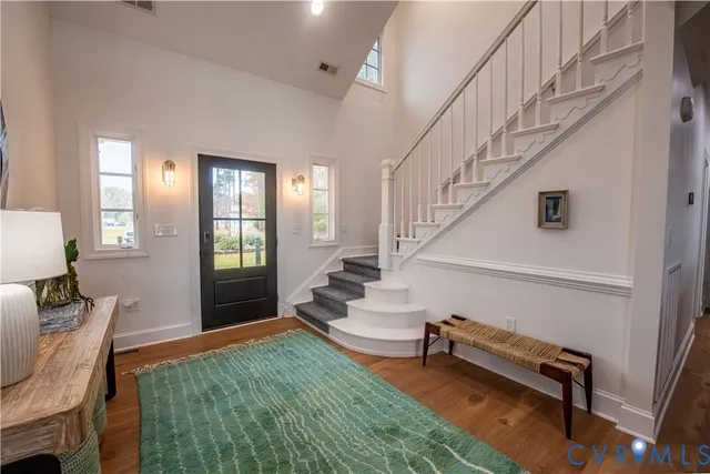 a living room with furniture fireplace and a large window