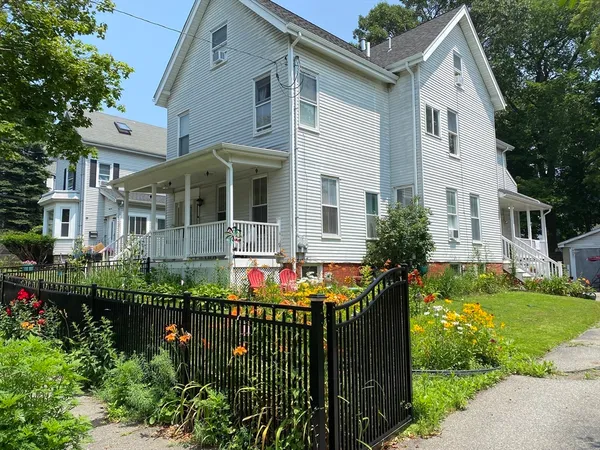 a front view of house with yard and green space